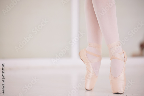 Ballet feet, legs or tiptoe of an elegant dancer dancing in a dance studio practicing for a performance. Closeup of a skilled and talented ballerina training or performing in a class