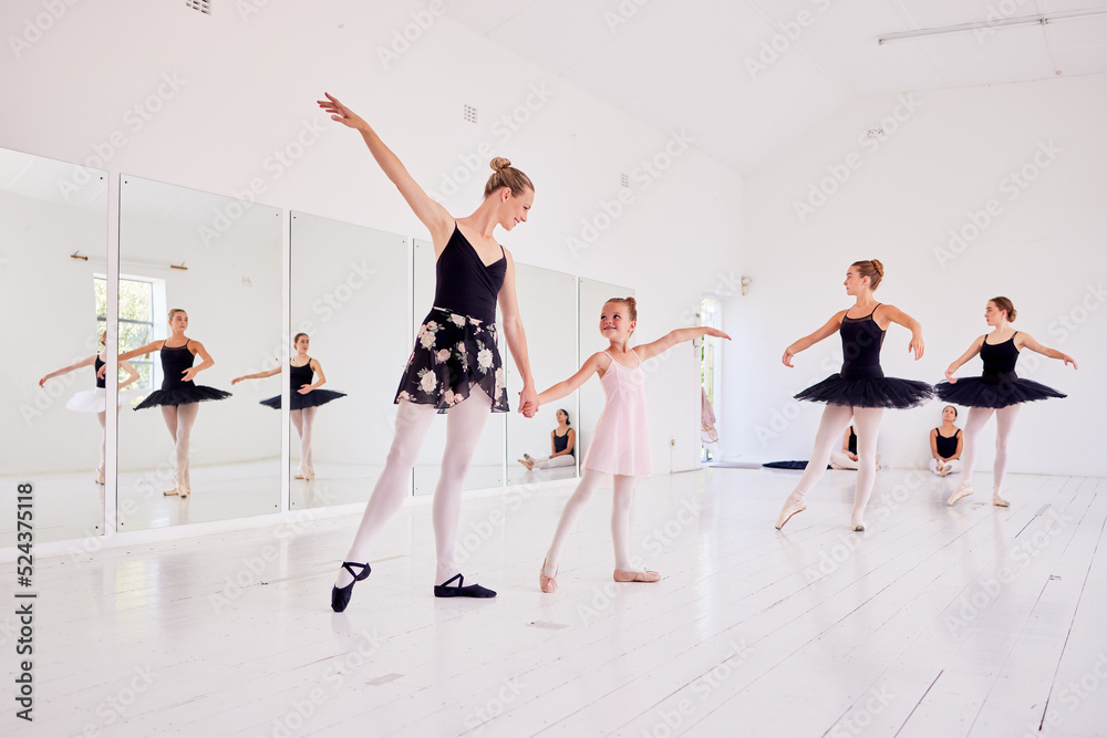 Ballet instructor or teacher teaching a young dancer in a class or dance studio preparing her for a performance. Young little girl learning to be a ballerina getting training for a coach