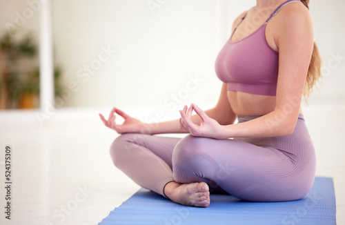Yoga meditation, zen and mudra hand gesture in lotus pose for fit, exercise and workout. Calm energy, relax and focused woman with legs crossed while training for peace, balance and healthy lifestyle