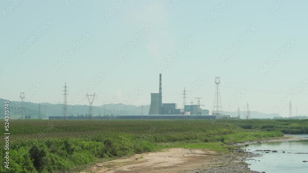 Thermal power plant in the distance on a sunny day Thermal power plant in the distance on a sunny day
