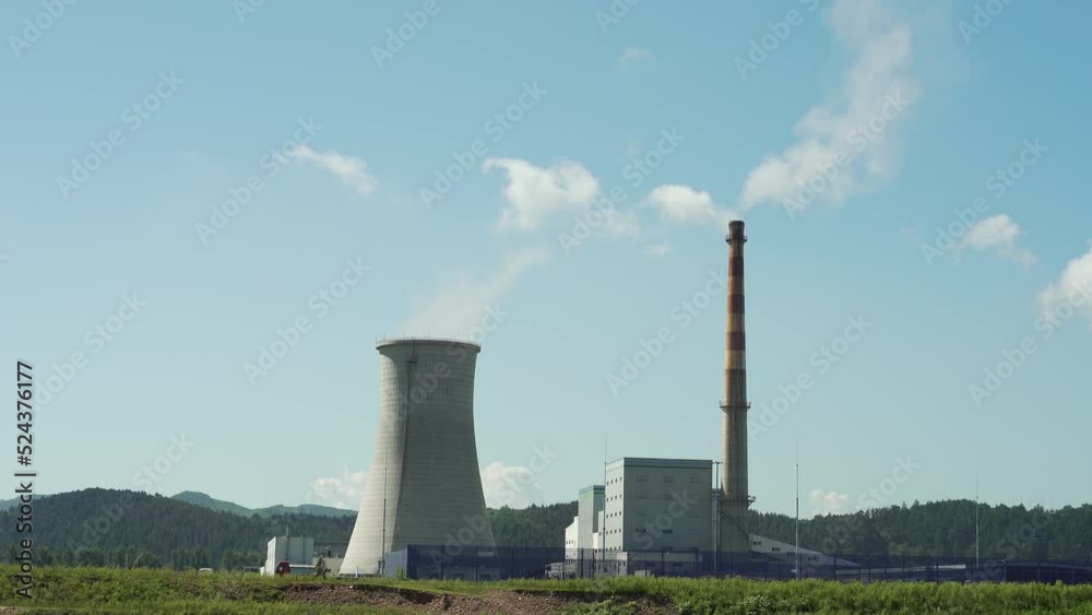 Thermal power plant in the distance on a sunny day Thermal power plant in the distance on a sunny day