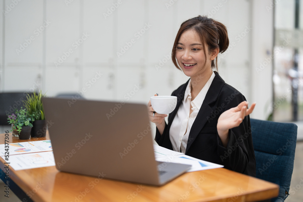 Asian female talking about sale report in video conference using laptop online meeting in video call. Working from home remotely. Asian female talking about sale report in video conference using laptop online meeting in video call. Working from home remotely.