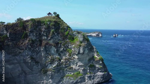 Aerial canamatic drone video in Nusa penida, drone rising up from behind cliff to show landscape