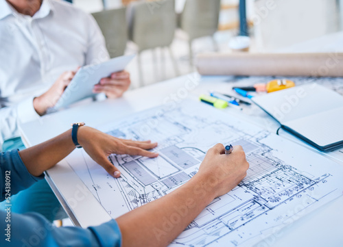 Architect sketching, designing blueprint or doing architecture, engineering or structure drawing on paper at a work studio with hands closeup. Business person working on a design project development