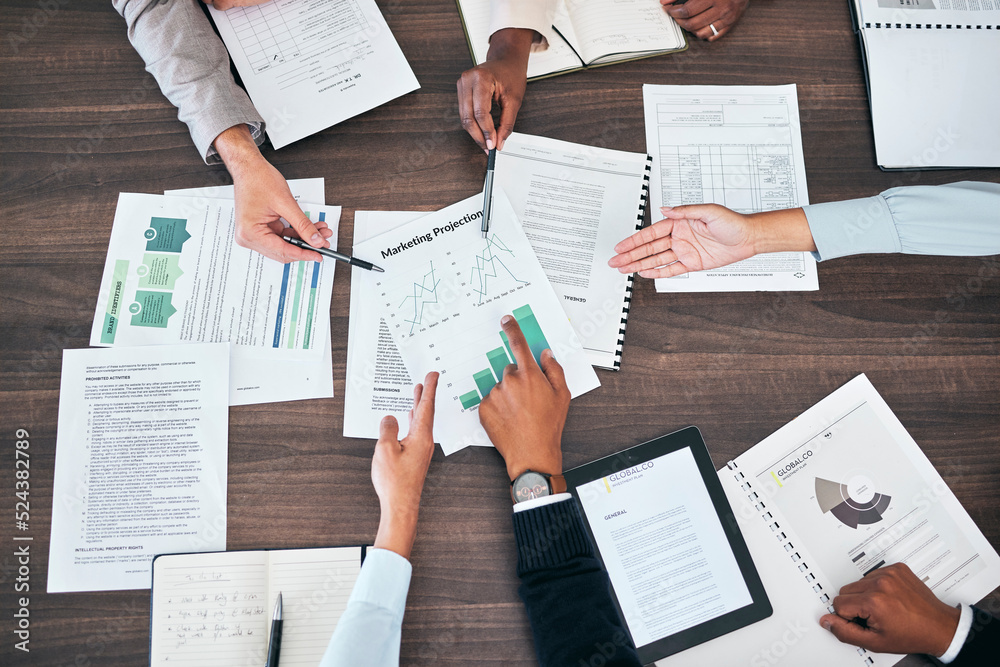 Obraz premium Business teamwork hands in a sales, marketing and forecasting projection meeting or group discussion about company strategy for growth development. Top view of people looking at chart, graph and data