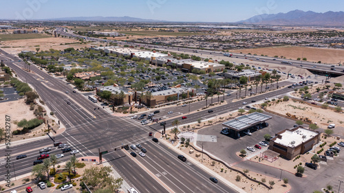 Afternoon aerial view of new shopping mall sprawl and empty lots of downtown Goodyear, Arizona, USA.