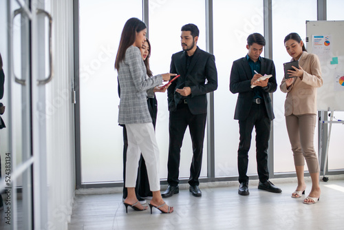 Business team male and female colleagues talking at work share ideas with data report in hands, Happy colleagues work together in office.