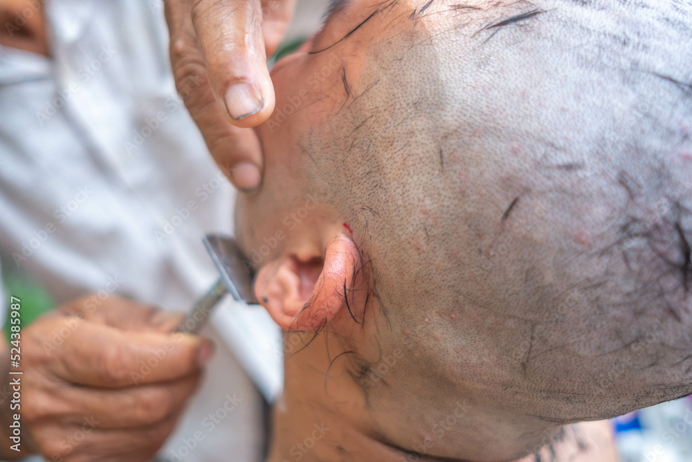 Buddhist monks shave their hair to be ordained a priest.Ceremony remove hair before to be monk.Hairdresser makes hairstyle bald man. Buddhist monks shave their hair to be ordained a priest.Ceremony remove hair before to be monk.Hairdresser makes hairstyle bald man.