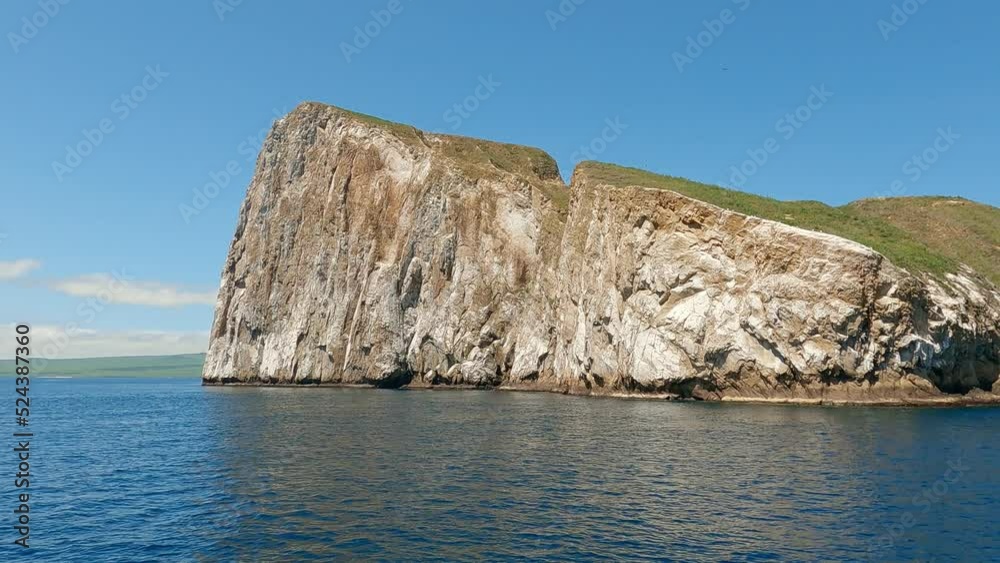 Boat sailing around the famous Kicker rock in the Galapagos islands in the Pacific ocean in Ecuador in South America Boat sailing around the famous Kicker rock in the Galapagos islands in the Pacific ocean in Ecuador in South America