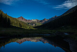 Mountain reflection in alpine valley pond