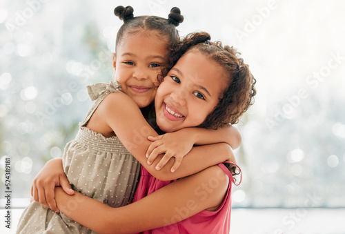 Obraz na płótnie Cute, adorable and sweet girls hugging and bond with a happy and healthy childhood growing at home