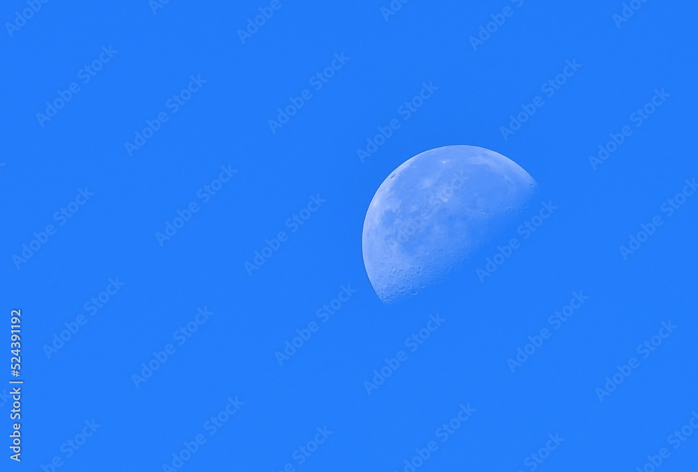 The moon in the morning sun on the blue sky The moon in the morning sun on the blue sky