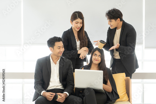 Happy office concept - concentrated business team with laptop computers in office. Happy Business team of entrepreneurs working together. Funny moment in business.