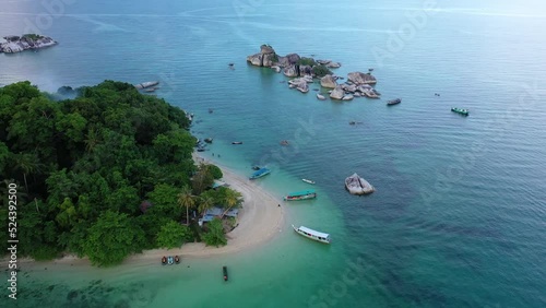 Belitung, Indonesia: Aerial drone footage of the stunning Kelayang island in Belitung in the Java sea in Indonesia, Southeast Asia. Shot with a tilt down motion.  photo