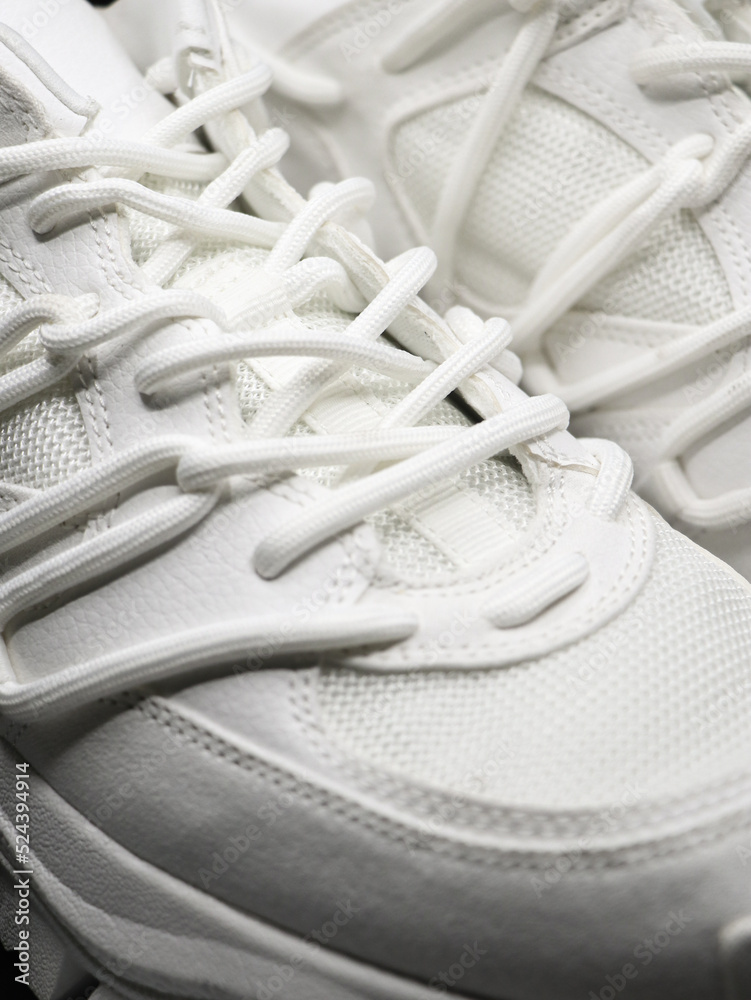 closeup isolated shot of white running shoes with white laces and nice stitching