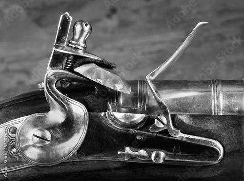 Closeup of Antique Flintlock Gun in black and white. photo