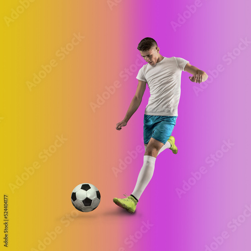 Professional soccer player hitting ball for winning goal in action on gradient multicolored neon background. Concept of sport competition. © Andrii IURLOV