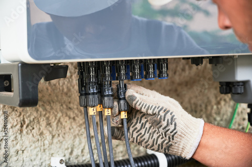 Photos Man electrician installing solar panel system
