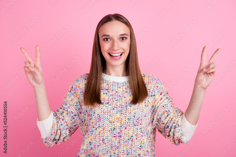 Portrait of cute nice lady showing making v-signs wearing knitted pullover isolated over pink background Portrait of cute nice lady showing making v-signs wearing knitted pullover isolated over pink background