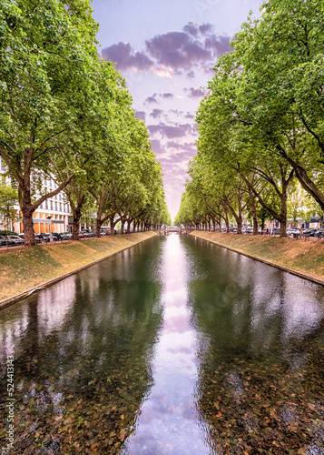 Konigsallee - a popular tourist and historical attraction of the city of Dusseldorf in Germany. A canal planted with plane trees with fashionable shopping galleries photo