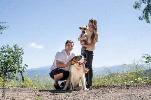 Canvas Print young couple travelling with dogs at the mountains, St