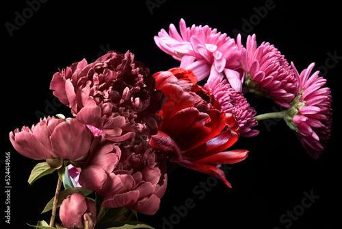 Fototapeta Naklejka Na Ścianę i Meble -  Red flowers on a black background, floral bouquet, chrysanthemum peonies and tulips.