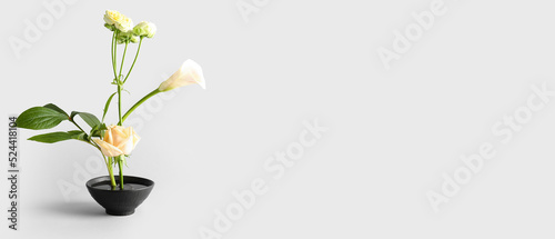 Beautiful ikebana on light background with space for text photo
