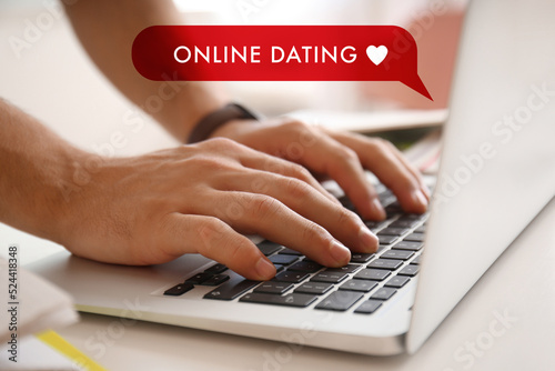 Young man using laptop, closeup. Online dating concept