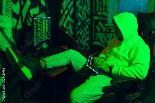 Hacker in hoodie working hacks code site on personal computer