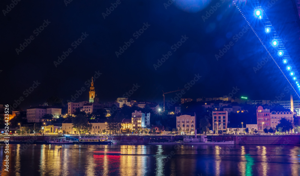 View of the historical city center and the Sava river in Belgrade, capital of Serbia at night. Shot with glares and bokeh
