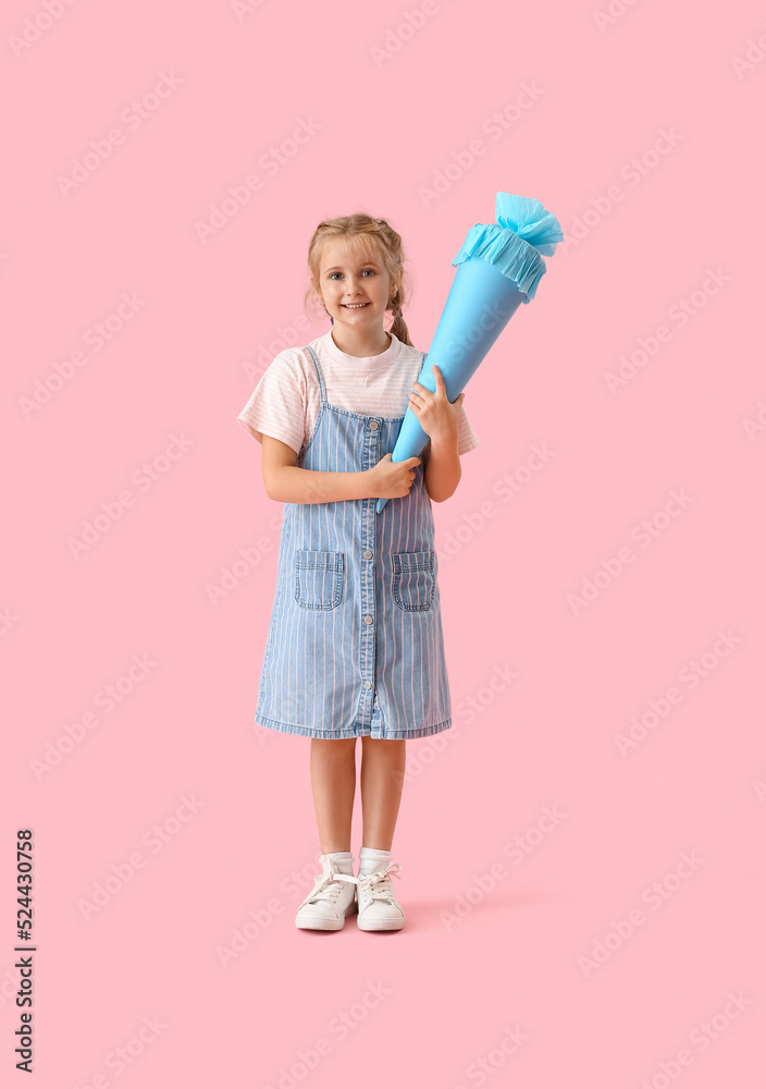 Cute little girl with blue school cone on pink background Cute little girl with blue school cone on pink background