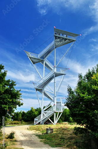 Metal observation tower in Slovakia with beautiful blue sky and clouds. Lookout tower Devinska Kobyla, Bratislava, Slovakia. A tourist attraction. photo