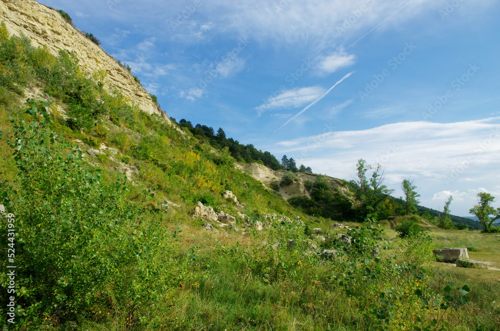 Beautiful summer day with green grass, meadow and blue sky panorama.  Sandberg hill in summer, Slovakia. Protected prehistoric area with sandstone.