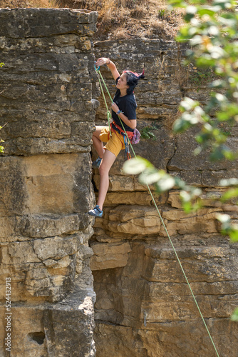 Teenage girl in a difficult rock climbing tour in the Rockgarden in Hessigheim, Neckar valley, Baden-Wuerttemberg, Germany 