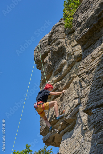 Teenage girl in a difficult rock climbing tour in the Rockgarden in Hessigheim, Neckar valley, Baden-Wuerttemberg, Germany 