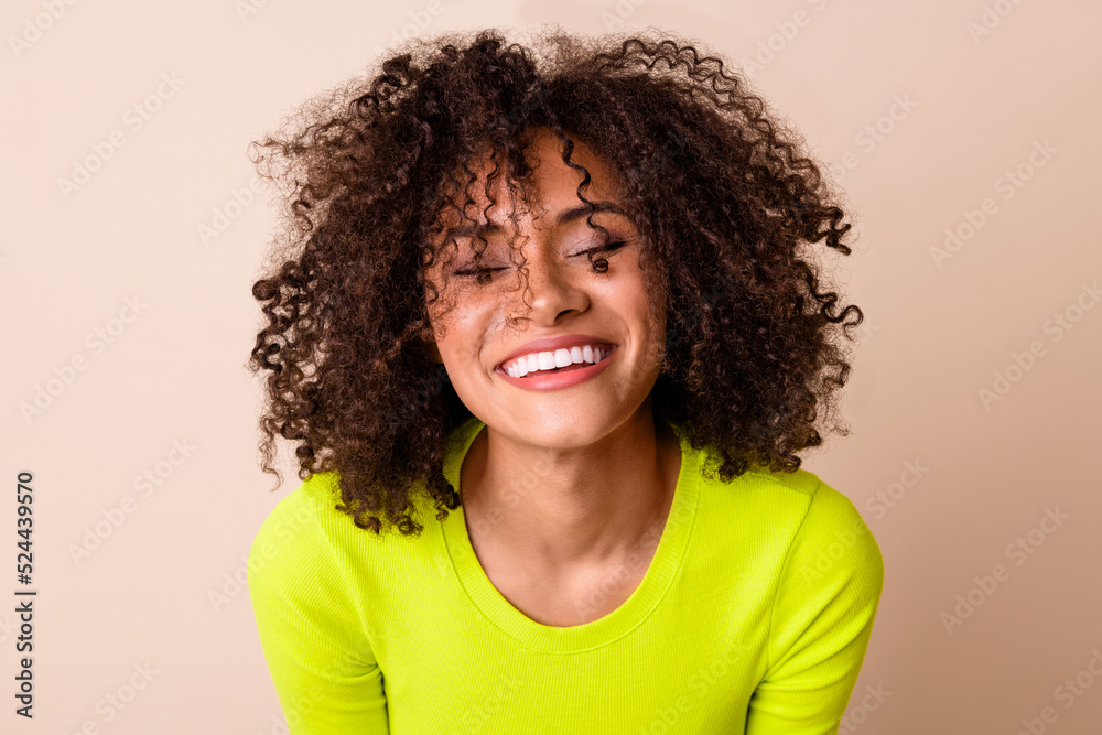 Photo of shiny adorable girl dressed neon shirt smiling laughing isolated beige color background Photo of shiny adorable girl dressed neon shirt smiling laughing isolated beige color background