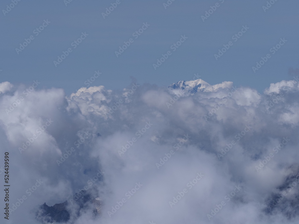 Foggy Mont Blanc peak above clouds seen from Switzerland Foggy Mont Blanc peak above clouds seen from Switzerland