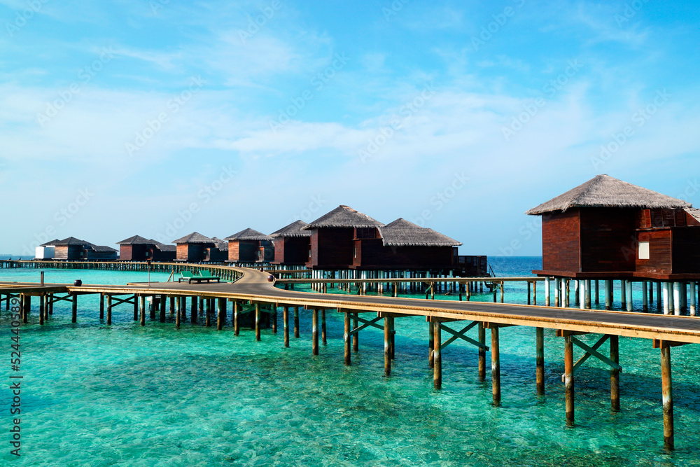 A tropical resort nestled at the south end of the Maldives in the heart of the Indian Ocean, picturing an array of overwater villas.