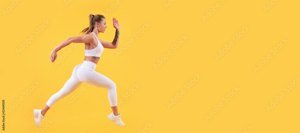 active sport girl runner running on yellow background. Woman jumping running banner with mock up copyspace.