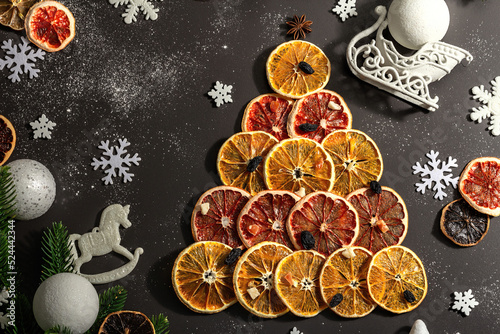 Festive fir tree from dried fruits. Christmas or New Year festive flat lay, food creative