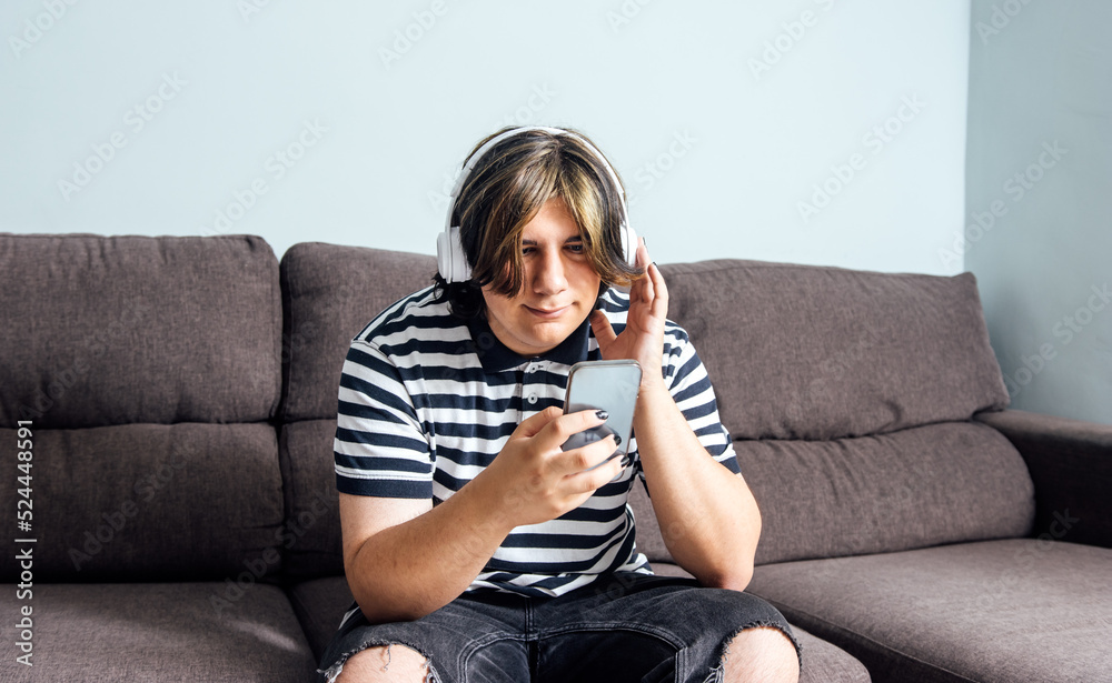 Teenager using headphones and smartphone