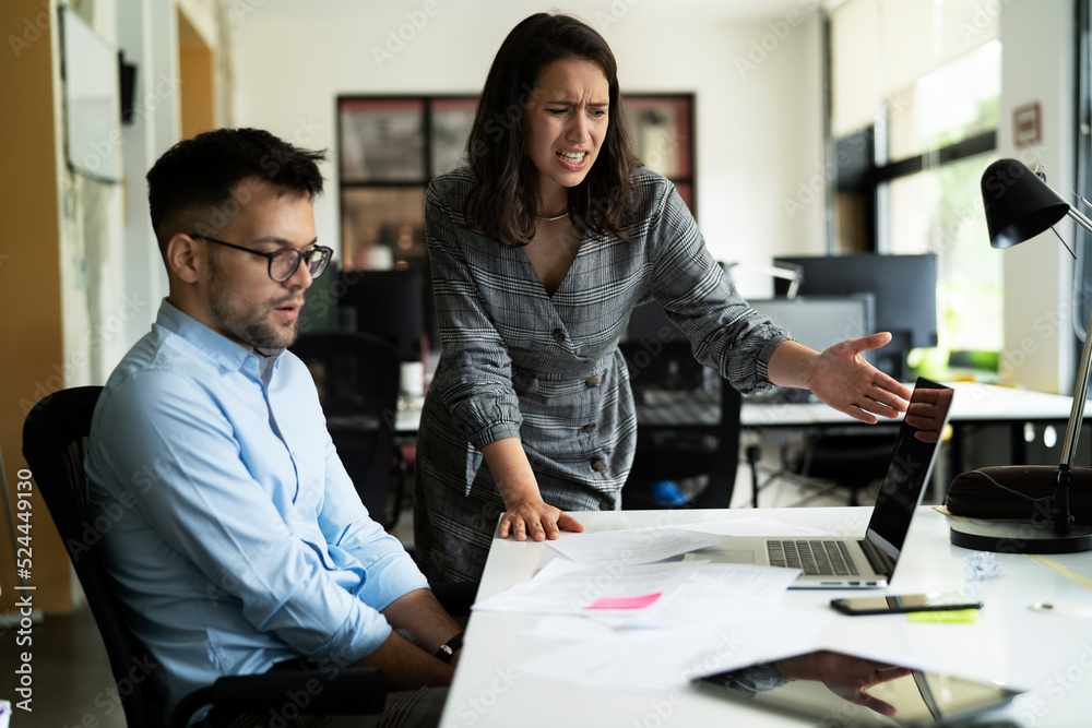 Colleagues arguing in office. Angry businesswoman yelling at her collegue. Colleagues arguing in office. Angry businesswoman yelling at her collegue.