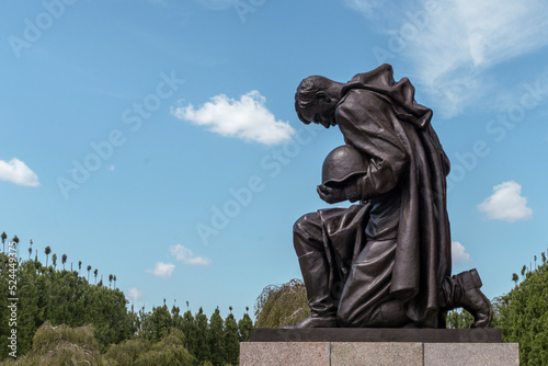 Berlin, Germany - 2022.07.30: Detail of the statue of a soldier bowing at Soviet War Memorial Treptow and military cemetery in the Treptower park.