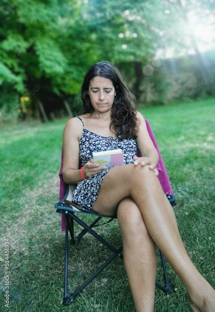 reading. Camping moments for a middle-aged woman on holiday. reading. Camping moments for a middle-aged woman on holiday.