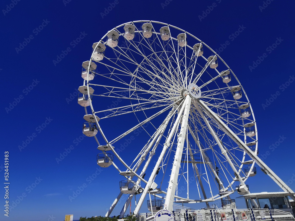 Views of a large white Ferris wheel