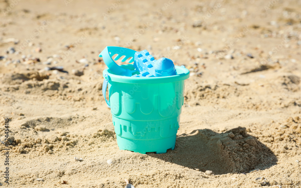 Different child plastic toys on sandy beach Different child plastic toys on sandy beach