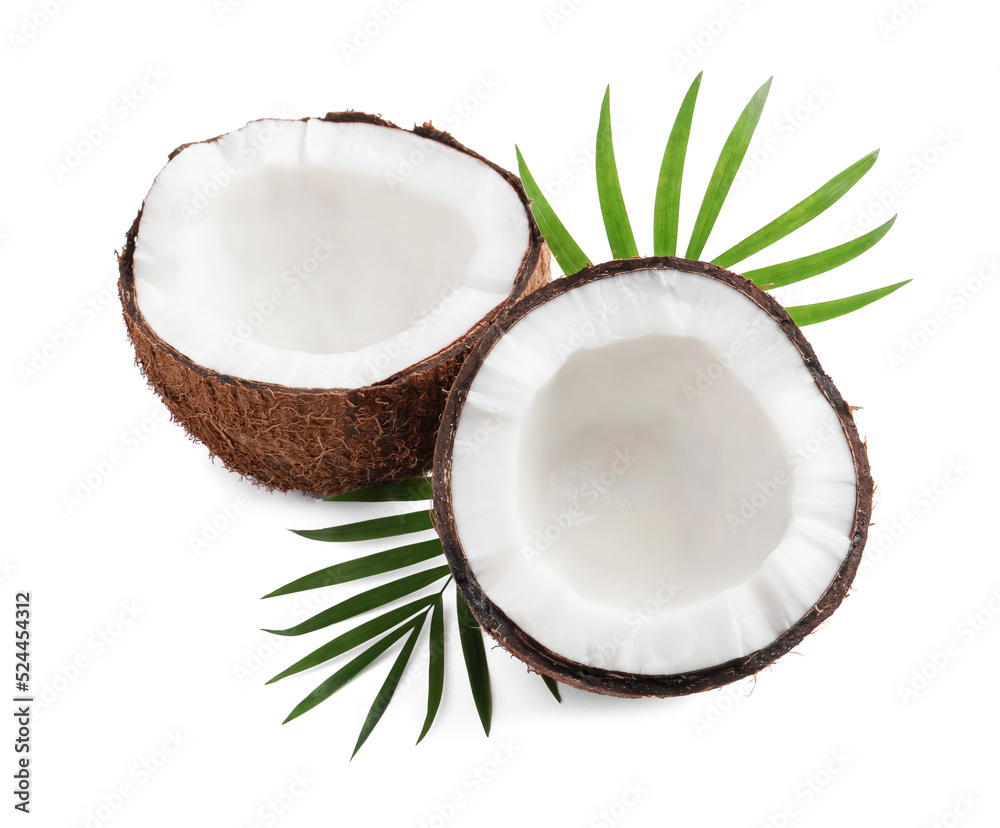 Halves of fresh ripe coconut with green leaves on white background Halves of fresh ripe coconut with green leaves on white background