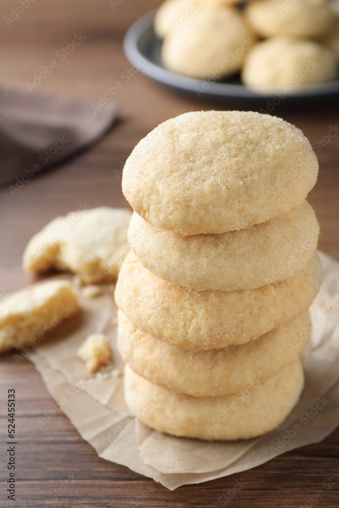 Stack of tasty sugar cookies on wooden table, closeup