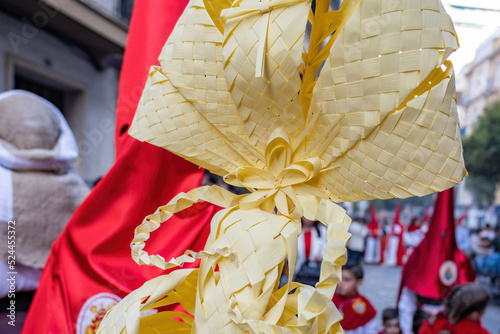 Detail of a Palm made in Elche, Spain, carried by a Nazarene and penitent, in Palm Sunday, during Holy Week, in the La Borriquita procession photo