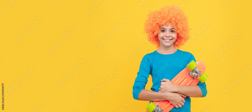 happy teen girl in fancy clown wig hold penny board, activity. Funny teenager child on party, poster banner header with copy space. happy teen girl in fancy clown wig hold penny board, activity. Funny teenager child on party, poster banner header with copy space.